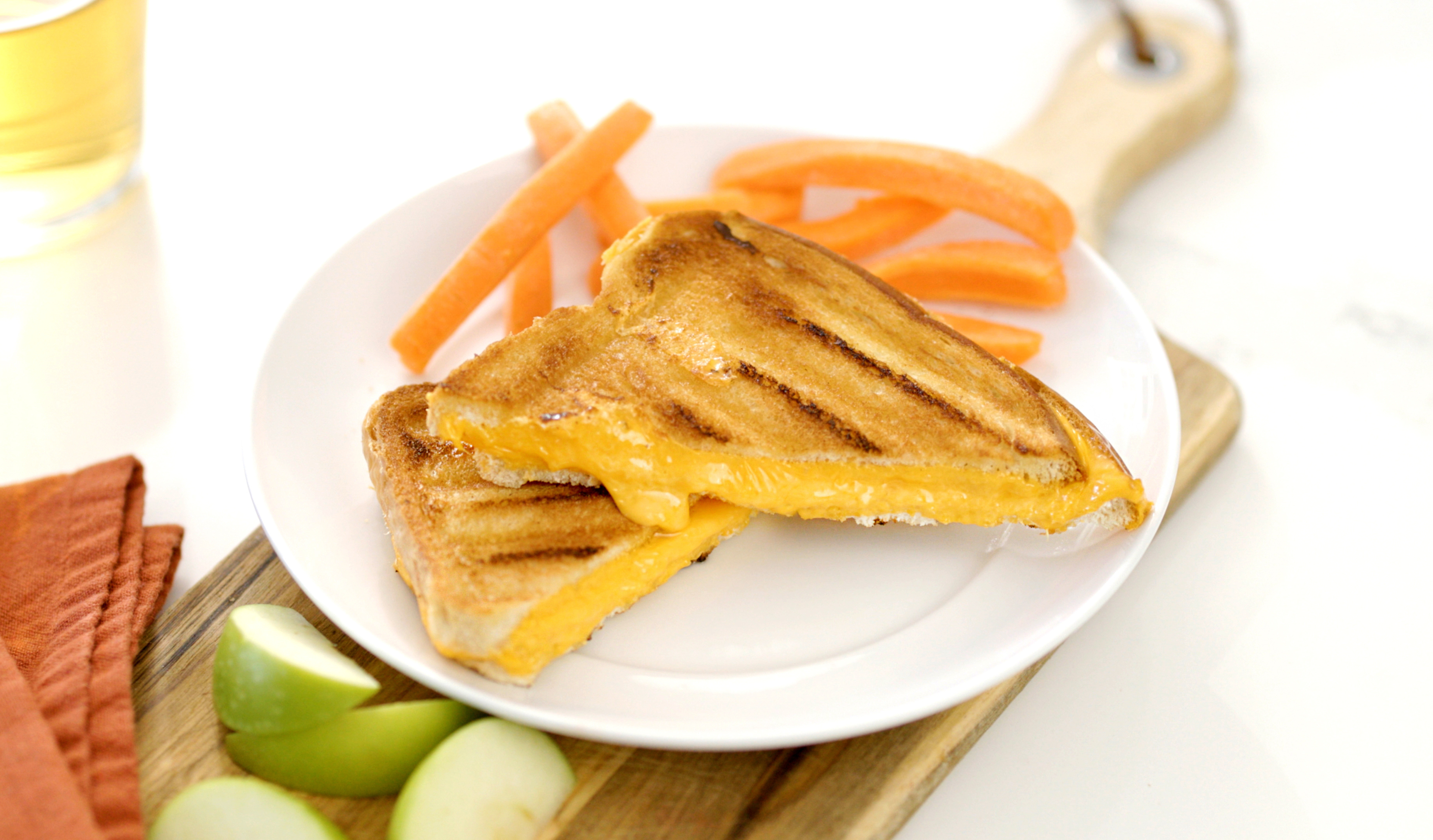 Crispy golden grilled cheese sandwich with melted cheddar oozing between two slices of toasted bread.