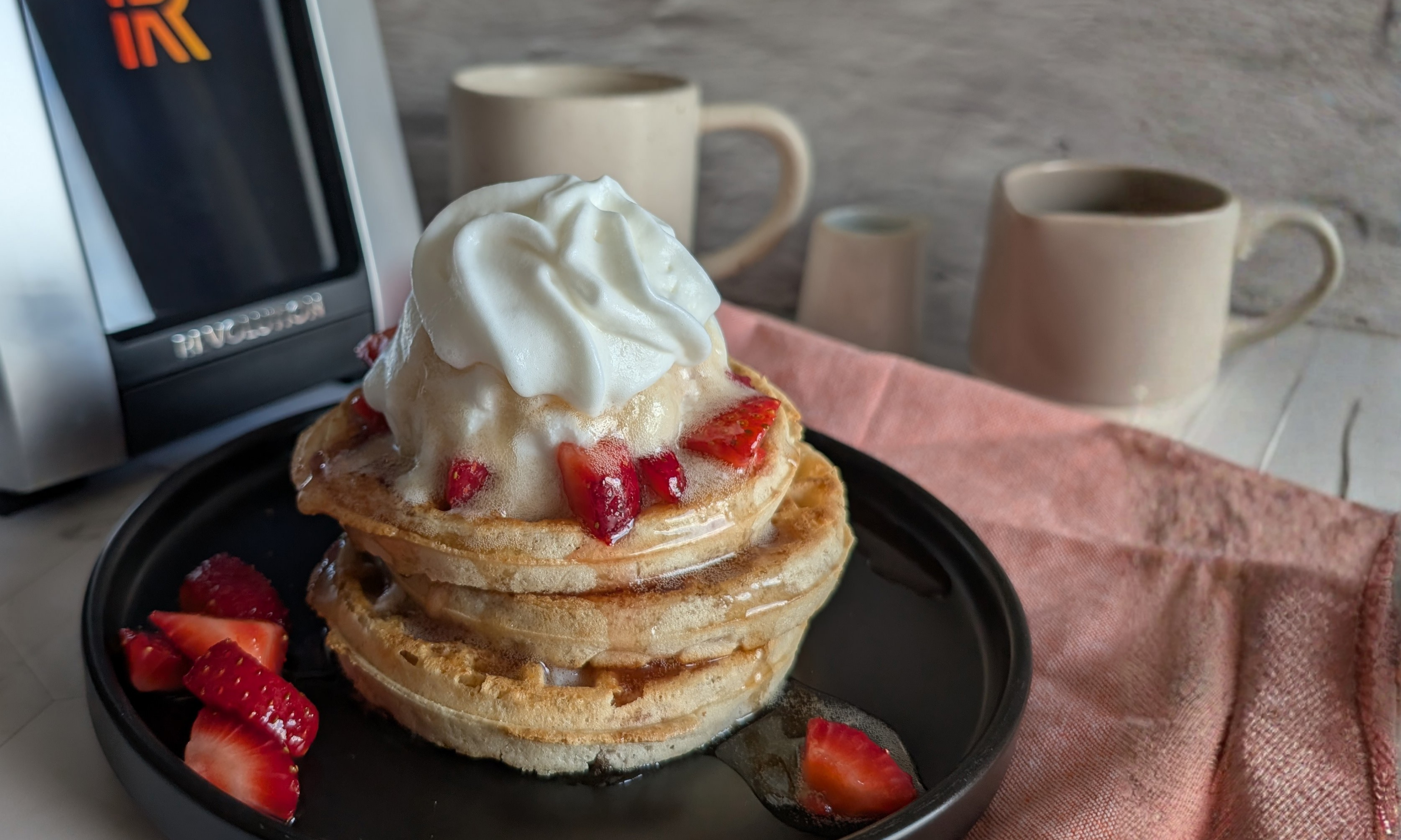 Gluten-free waffles with strawberries and whipped cream toasted in the Revolution Smart Toaster with gluten-free toast settings
