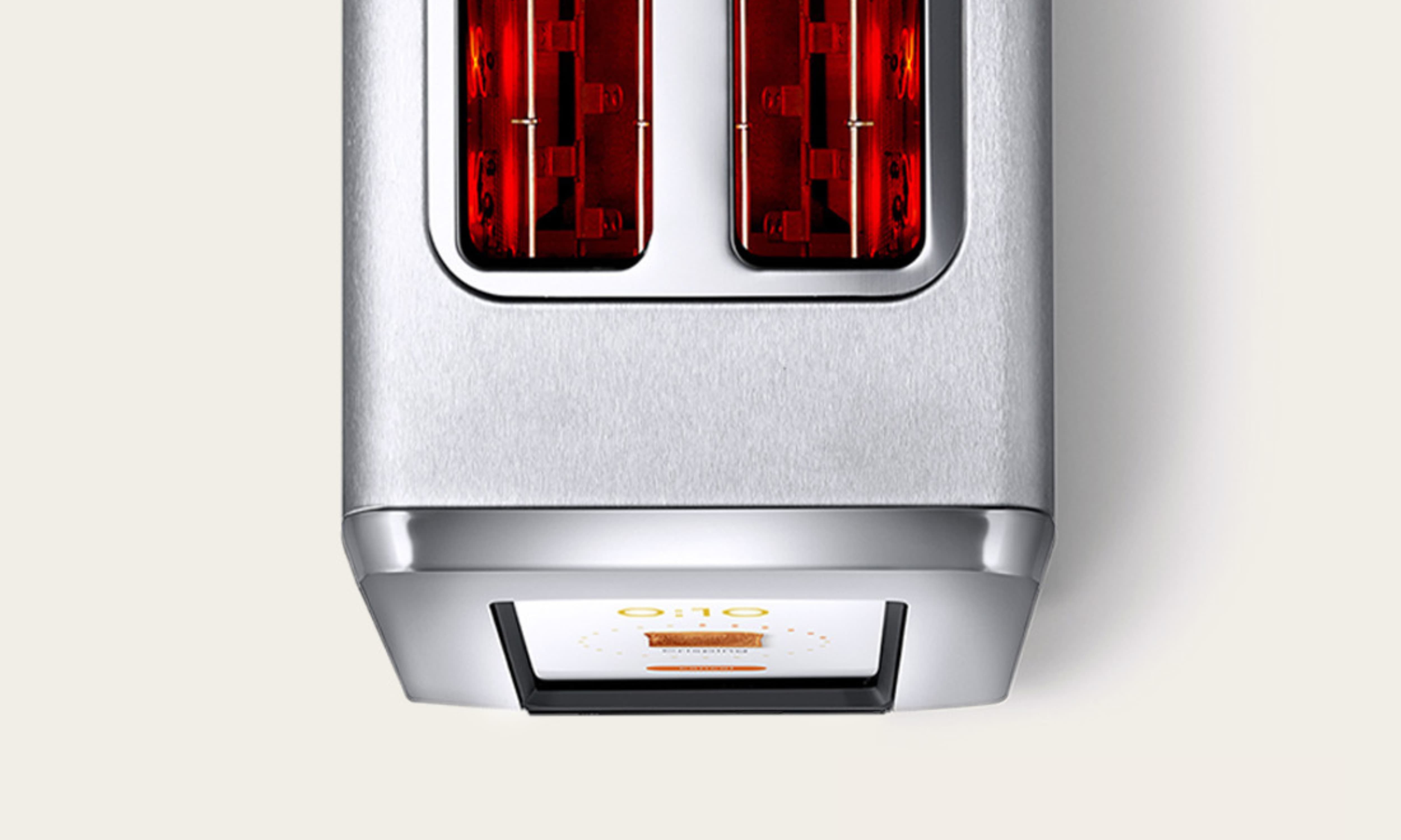 Overhead view of the Revolution R180 Connect Plus smart toaster toasting bread using InstaGLO® rapid heating technology and touchscreen controls.