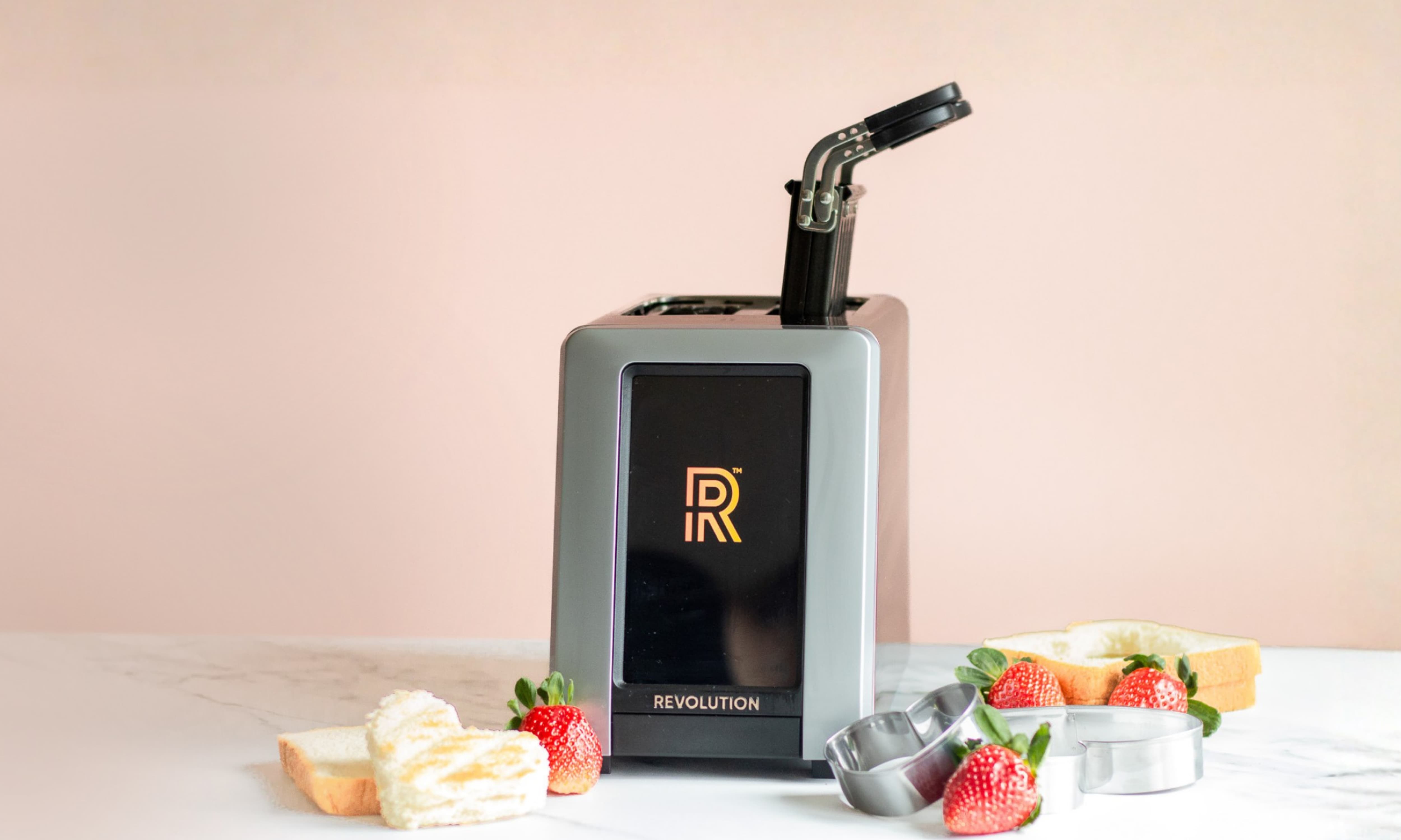 R180 Connect Plus smart toaster with Toastie Press on a marble countertop, featuring heart-shaped toast and strawberries for a Valentine’s Day gift scene.