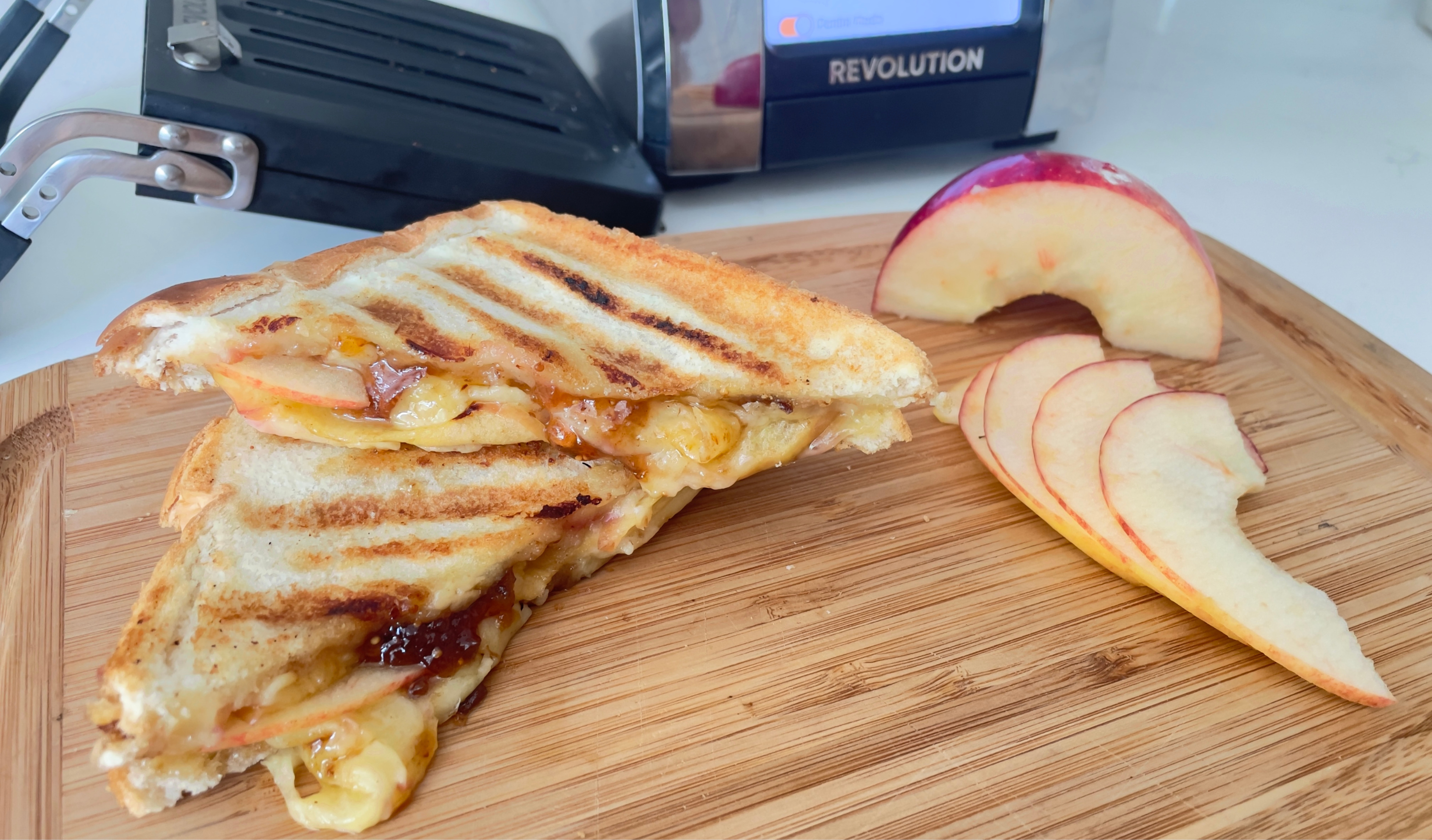 Cheddar, apple, and fig grilled cheese sandwich toasted golden in the Revolution Toastie Press™