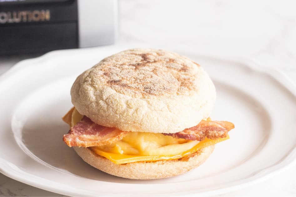 bacon egg and cheese breakfast sandwich on a gluten-free english muffin, cooked in the Revolution Smart toaster for gluten free toasting
