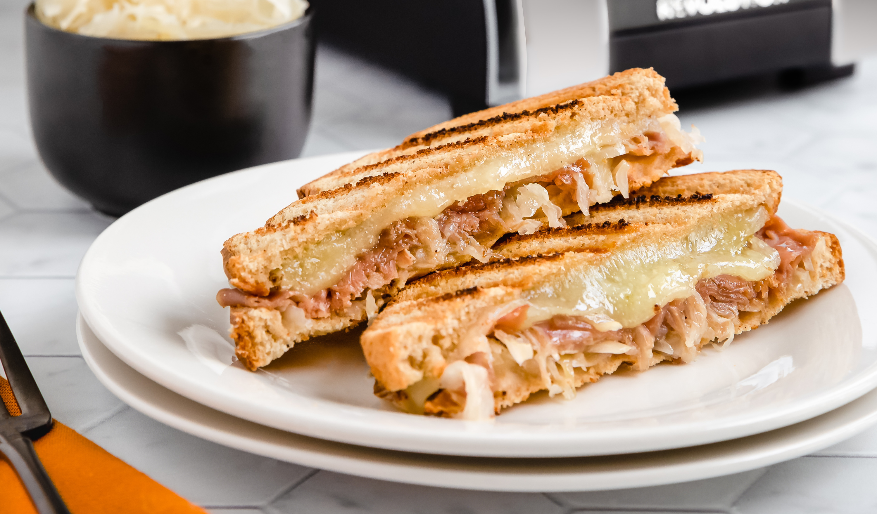 Bavarian grilled cheese sandwich with ham, Swiss cheese, and sauerkraut toasted in the Revolution Toastie Press