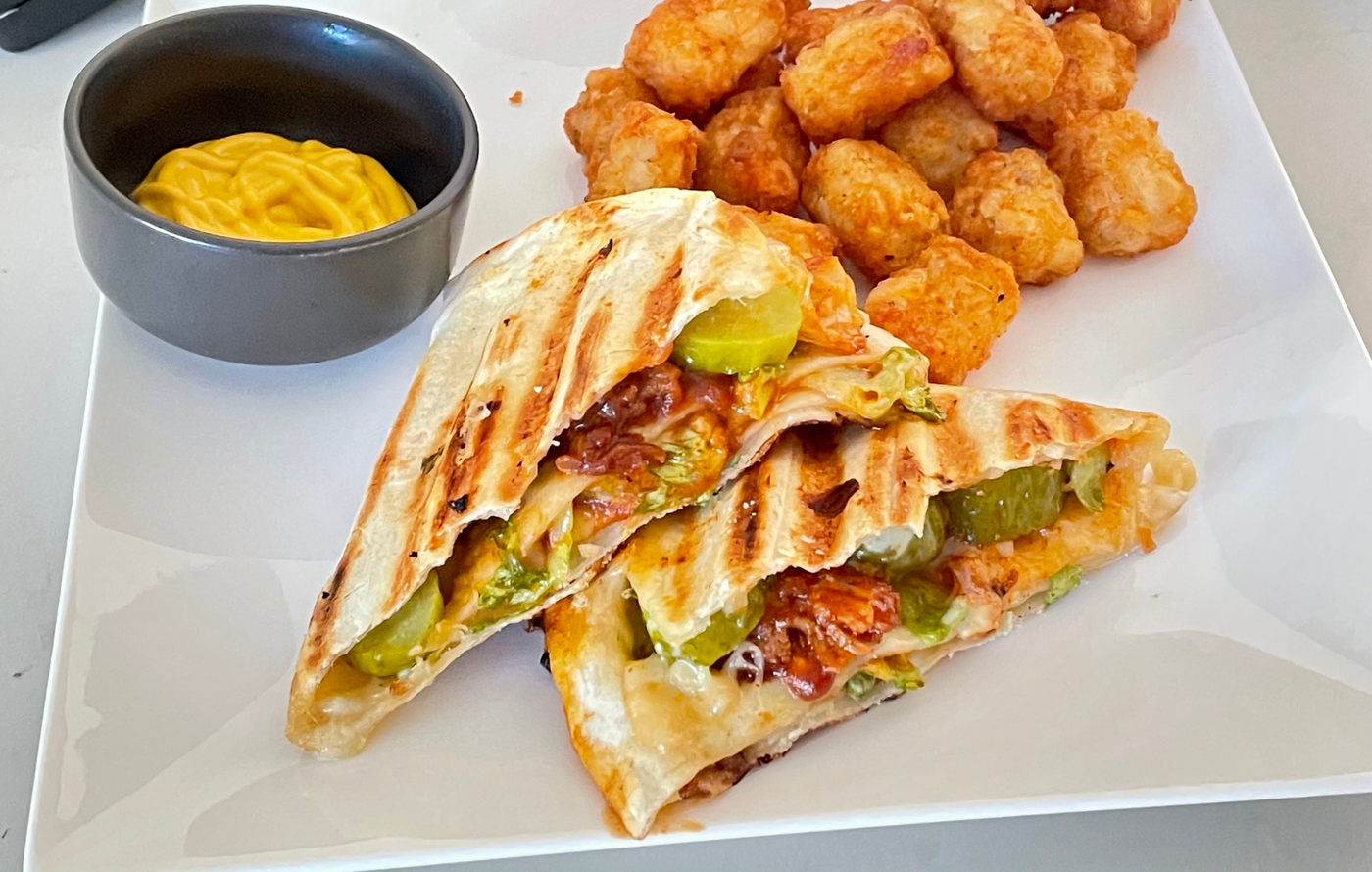 Pulled pork and pepper jack quesadilla folded into triangles and toasted in the Revolution Toastie Press™