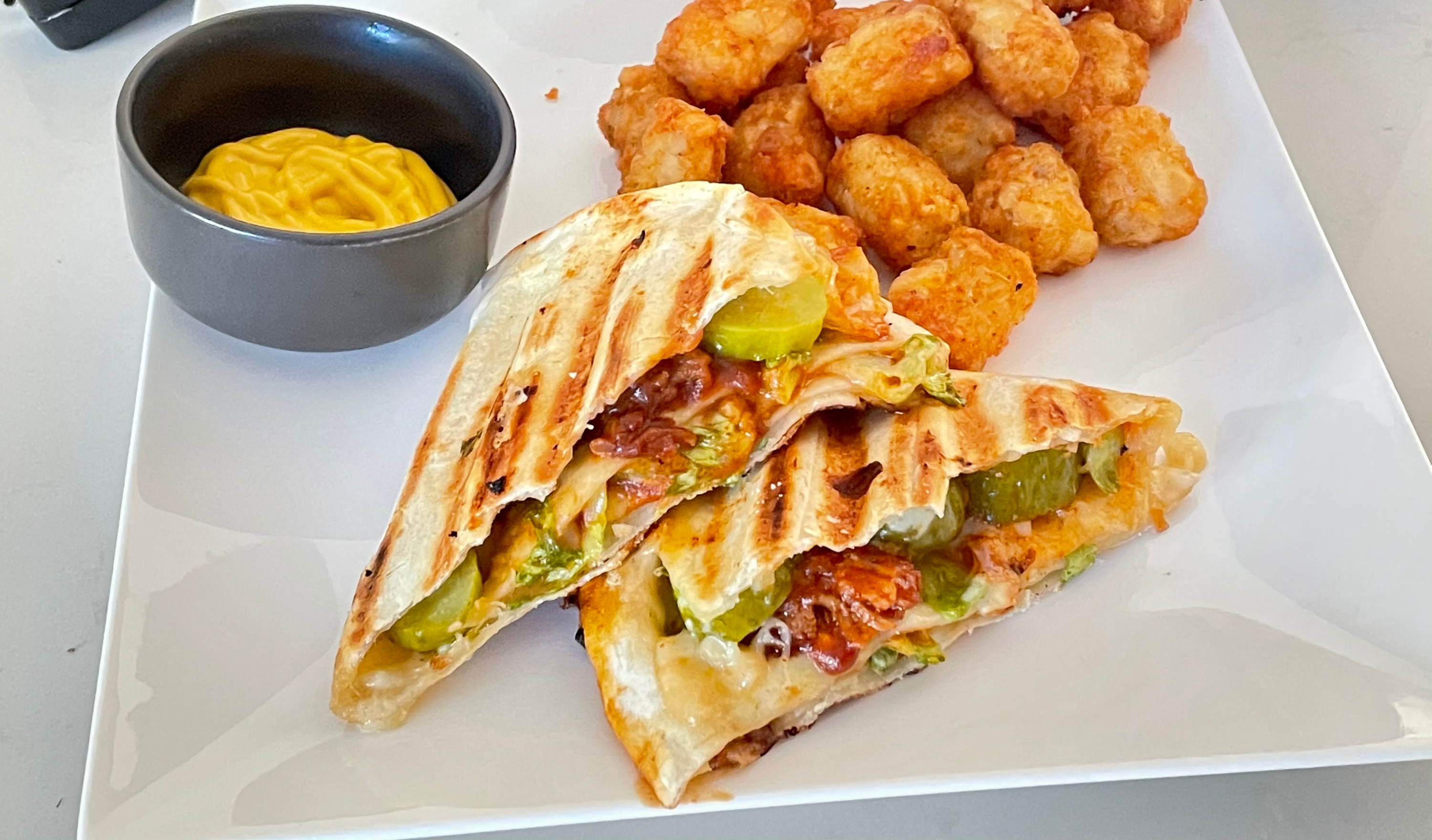 Pulled pork and pepper jack quesadilla folded into triangles and toasted in the Revolution Toastie Press™