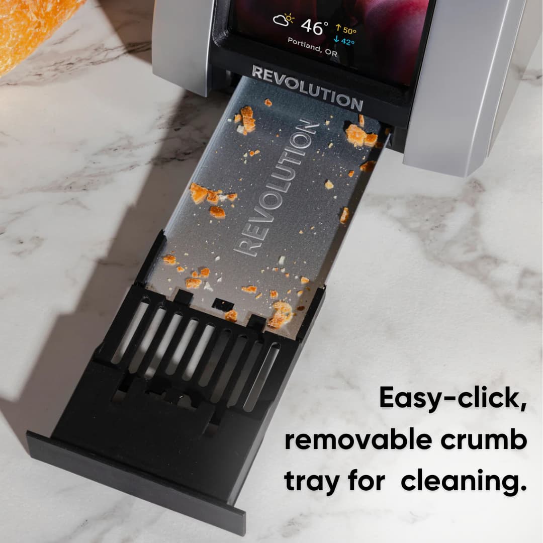 The R180 Connect Plus Smart Toaster + Toastie Press + Warming Rack by Revolution Cooking features an easy-click, removable crumb tray for cleaning. Shown on a marble countertop.
