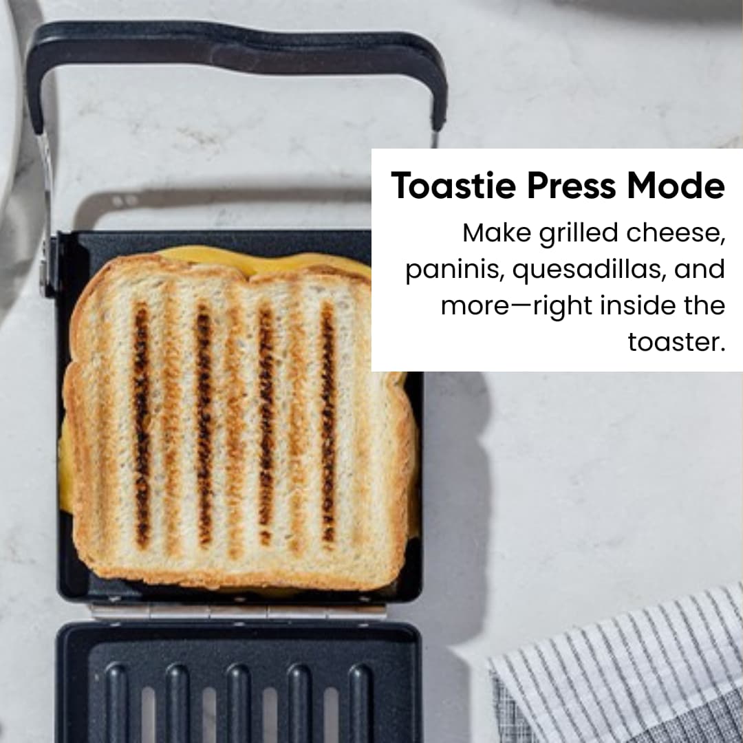 A grilled sandwich with grill marks sits in the Revolution Cooking R180 Connect Plus Smart Toaster + Toastie Press + Warming Rack. Text reads: "Toastie Press Mode: Make grilled cheese, paninis, quesadillas, and more—in your smart toaster.