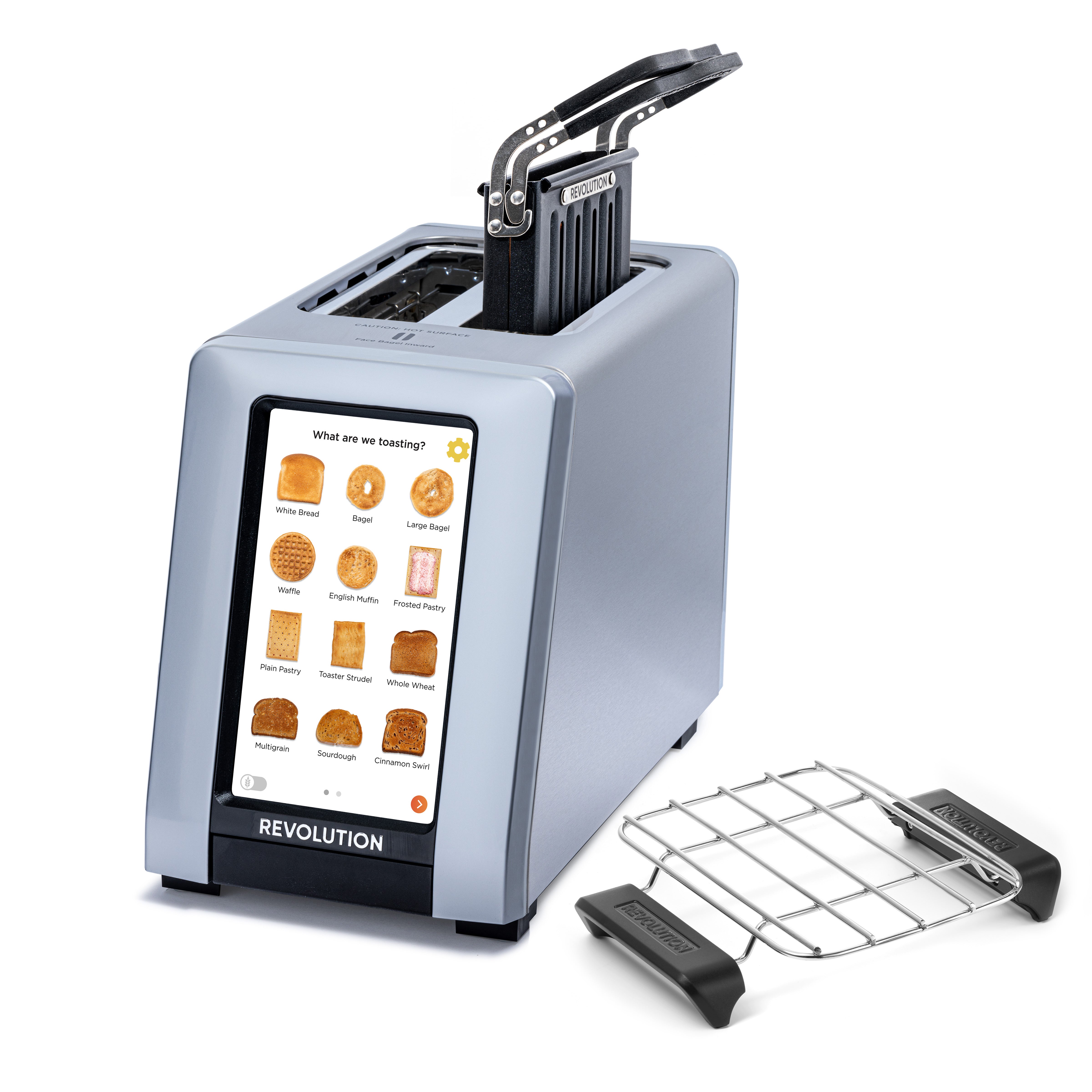 Introducing the R180 Connect Plus Smart Toaster by Revolution Cooking, a stylish appliance featuring a digital touchscreen for selecting various bread options. Its sleek design includes two slots on top and comes with a convenient removable crumb tray positioned beside it. Additionally, it includes a Toastie Press and Warming Rack for added functionality.