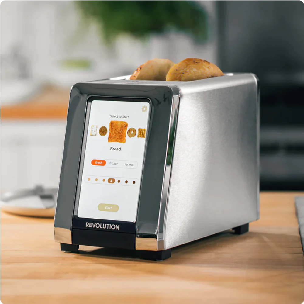 A modern toaster with a digital touch screen is toasting two slices of bread. The screen displays options for bread type and toasting preferences. The toaster is placed on a wooden kitchen counter with a blurred background.