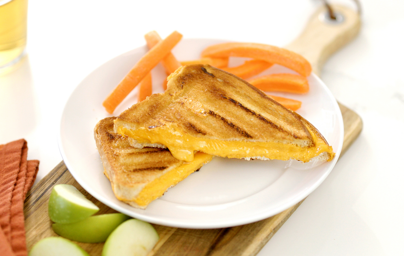 Crispy golden grilled cheese sandwich with melted cheddar oozing between two slices of toasted bread.