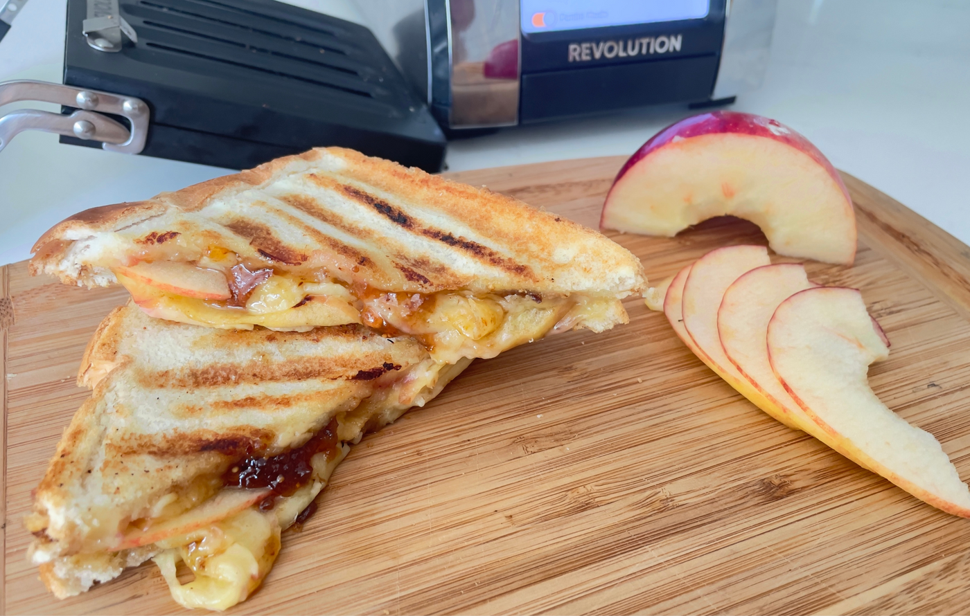 Cheddar, apple, and fig grilled cheese sandwich toasted golden in the Revolution Toastie Press™